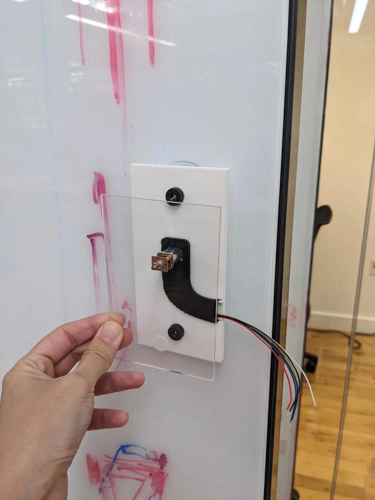 A close-up of the printed motor mount seated in the frame, wires tucked out of sight.