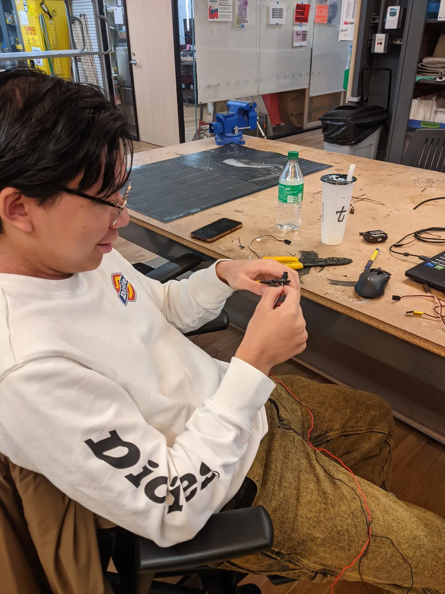 Photograph of wires being stripped in front of a jacket