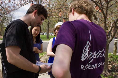 Photograph of a man and a group of students looking at a script