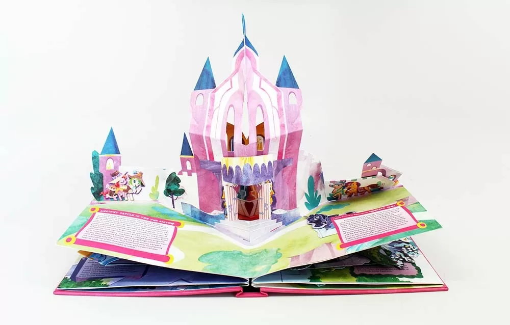 A photograph of a popup book with a castle emerging from two pages