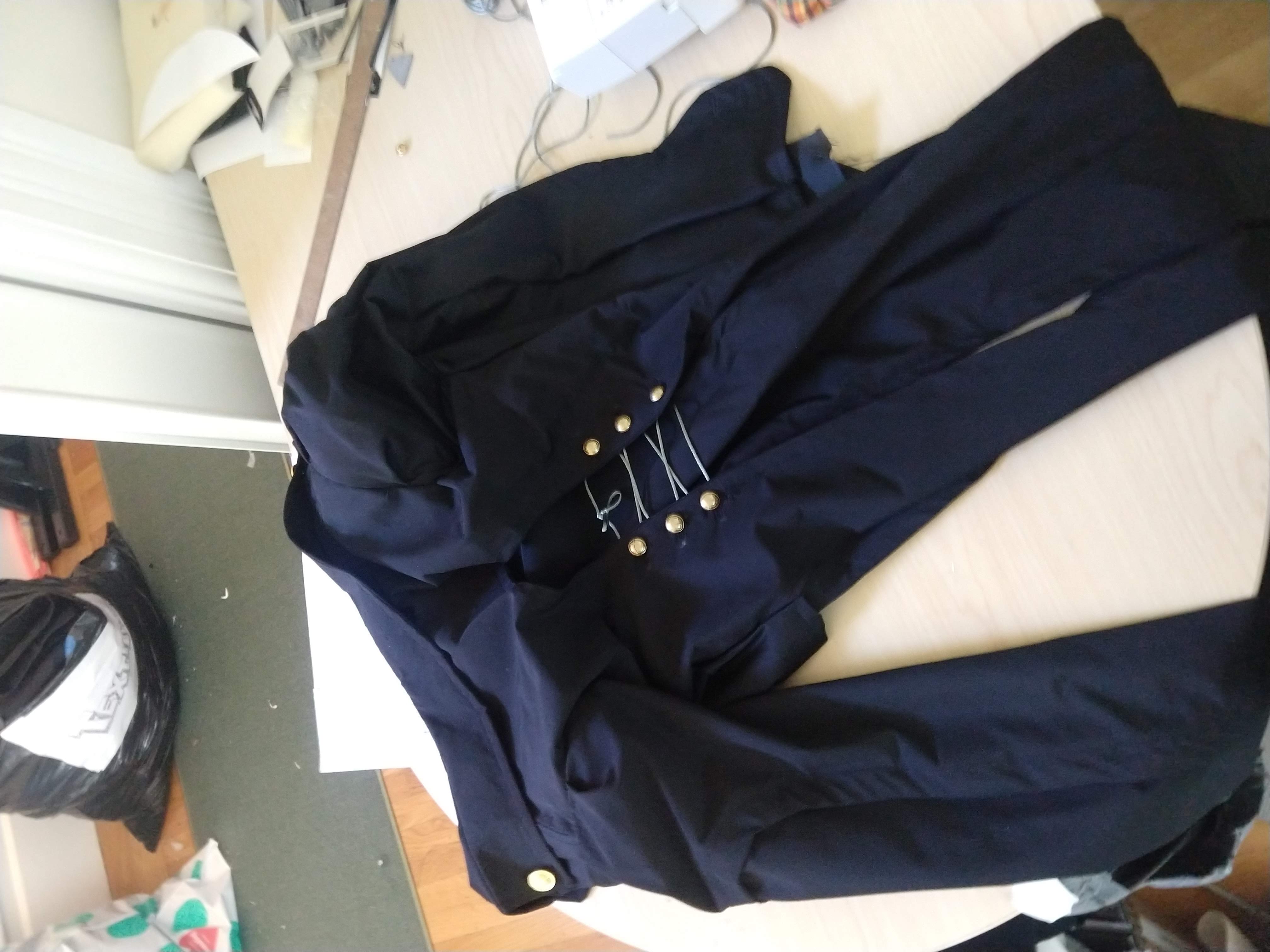 Photograph of a finished jacket laying face down on a table