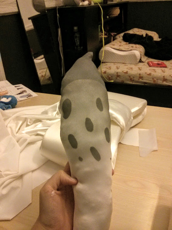 Photograph of a stuffed tentacle with gray spots