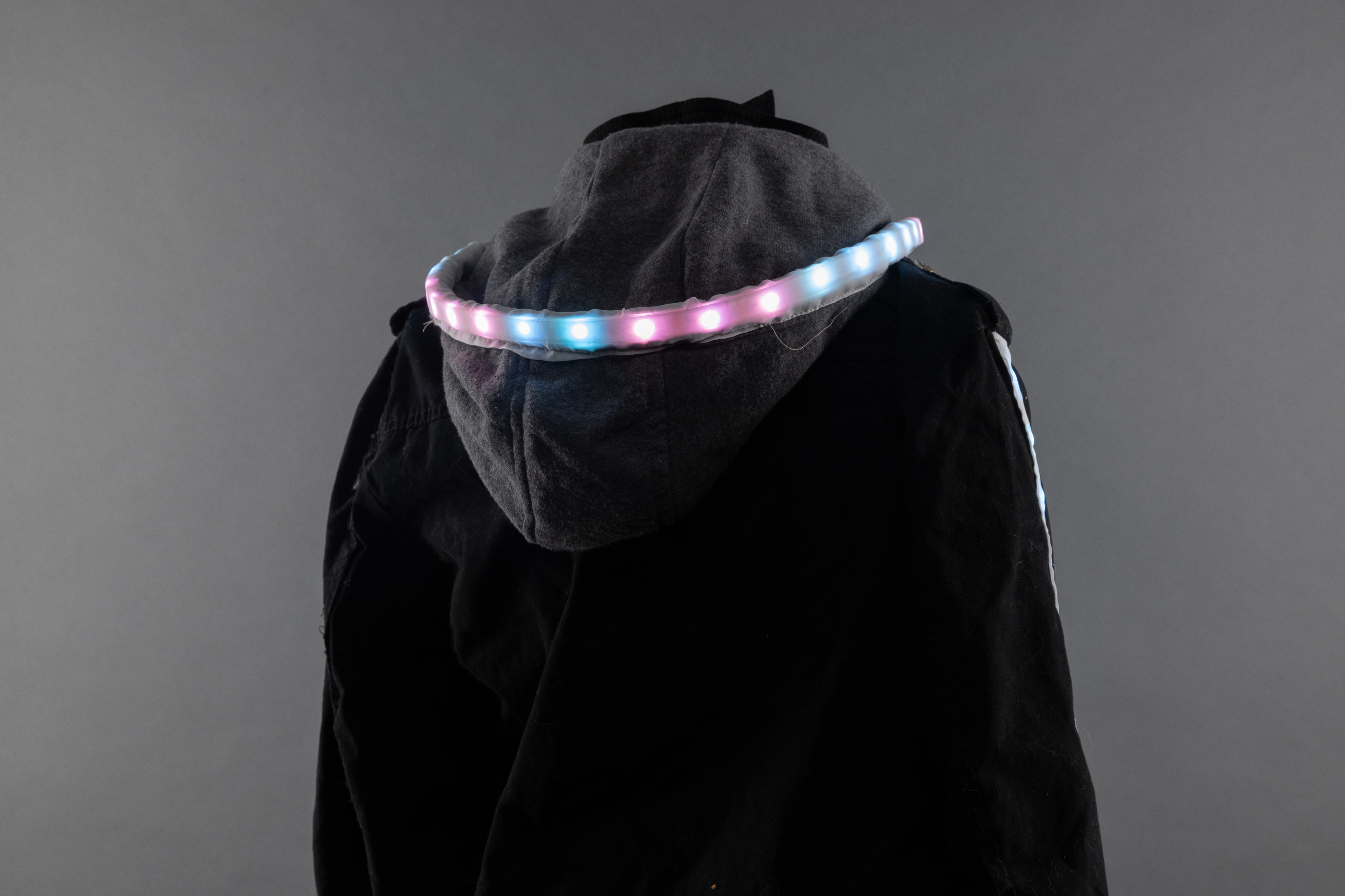 Photograph of the back of a jacket with LEDs circling the hood