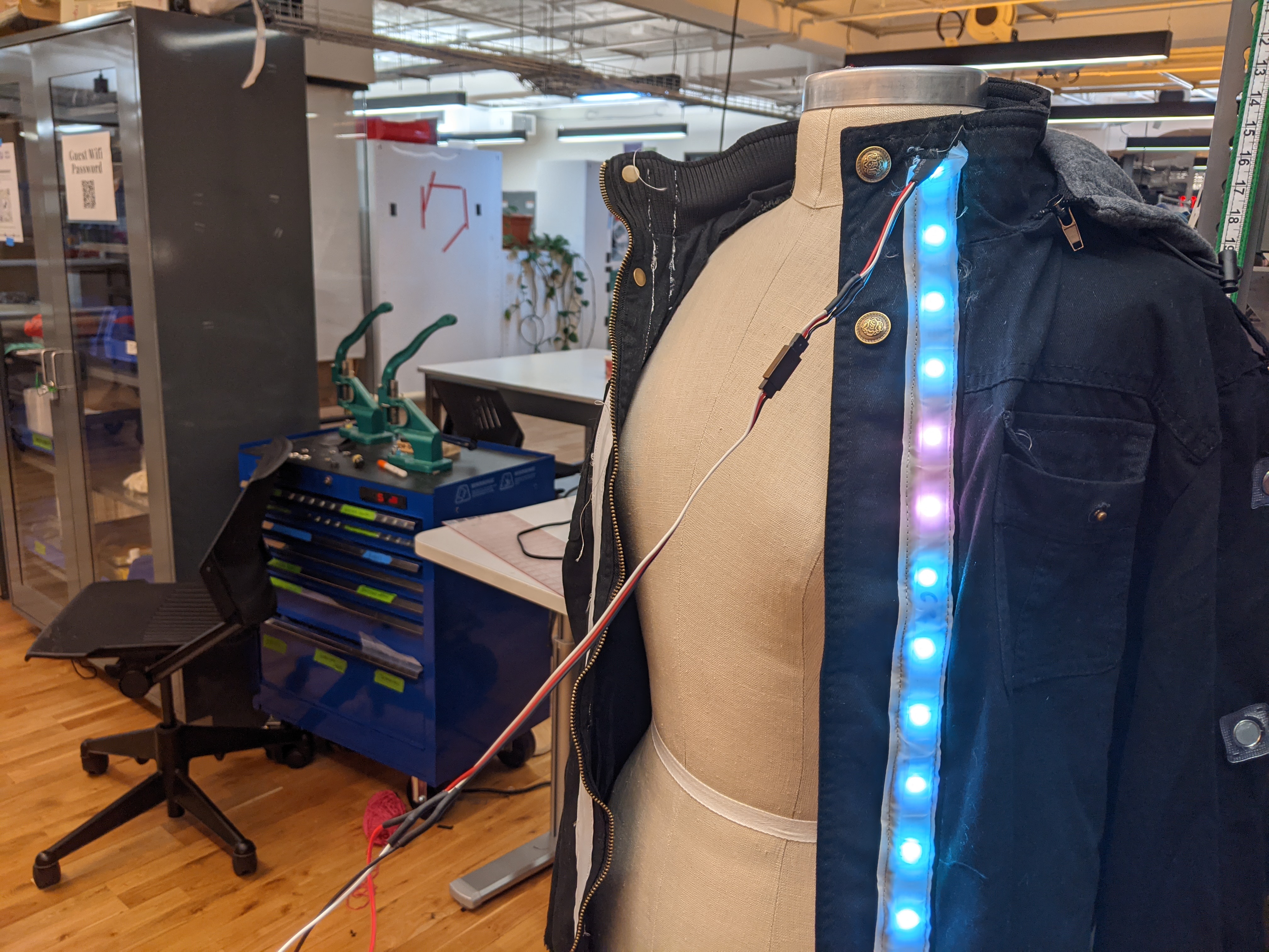 Photograph of a jacket on a mannequin with wires sticking out of it