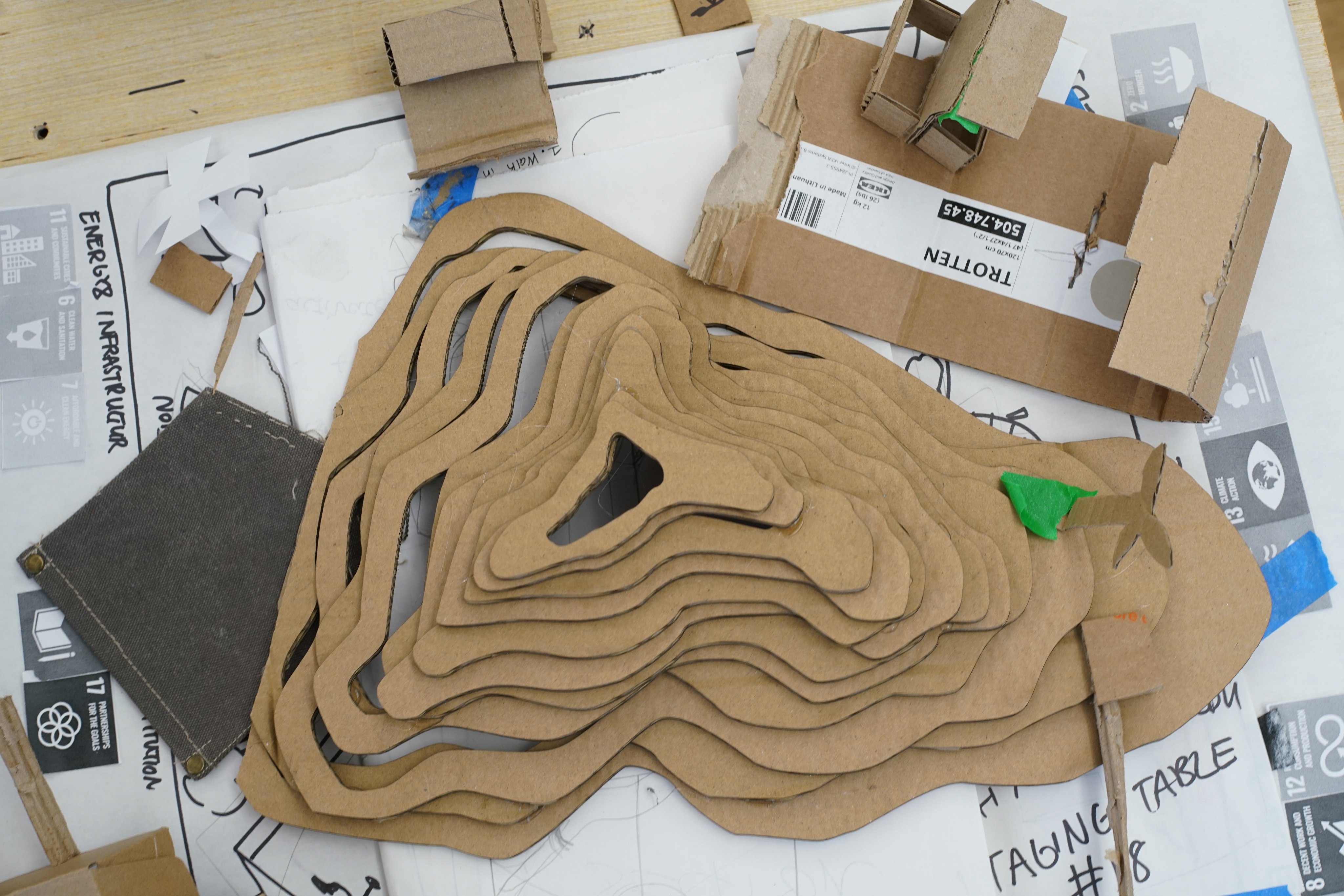 Photograph of a few organic shapes made of small cardboard stacked on top of each other