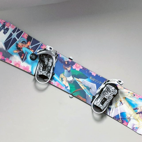 Photograph of a Zelda and Star Wars themed snowboard hanging on the wall